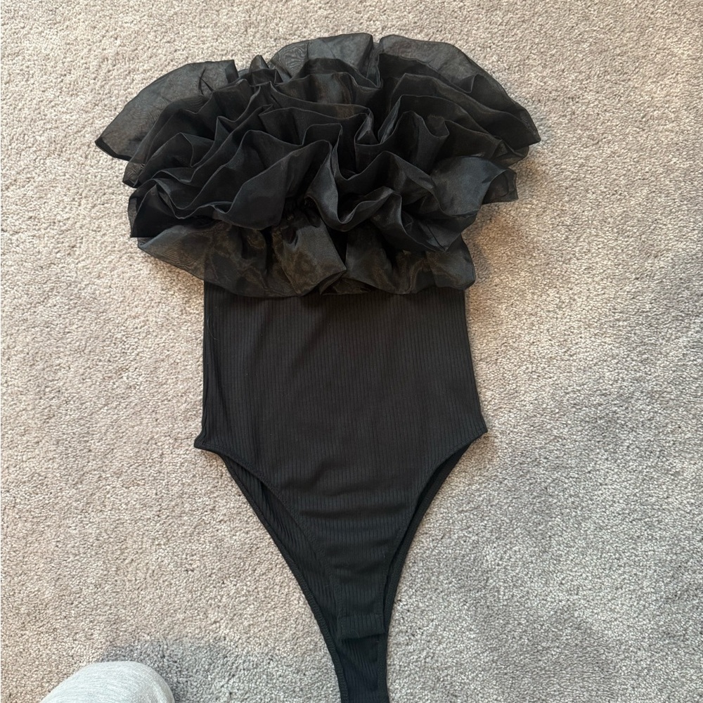 Woman’s Black Ruffle body suit.